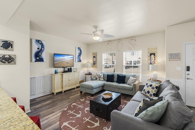 living room with dark wood-type flooring, radiator, and ceiling fan