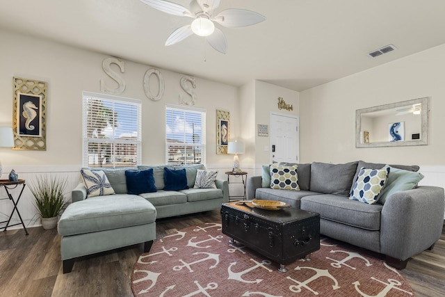 living room with ceiling fan and dark hardwood / wood-style flooring