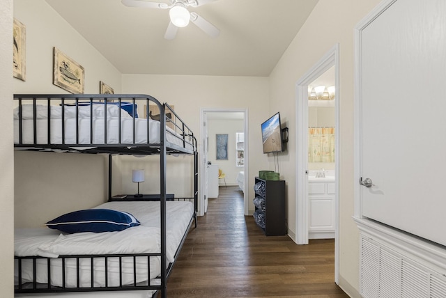 bedroom with ceiling fan, sink, dark hardwood / wood-style flooring, and ensuite bath