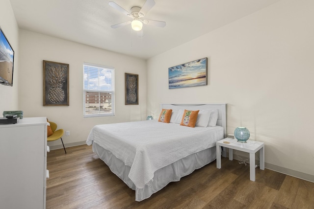 bedroom featuring ceiling fan and dark hardwood / wood-style floors