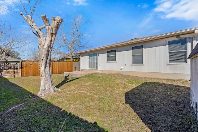 rear view of property with a patio and a lawn