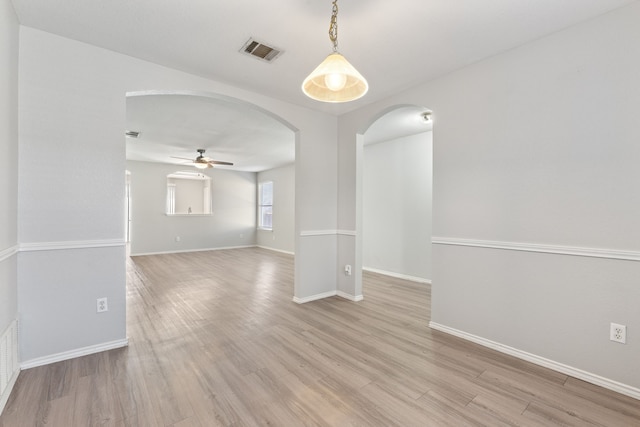 spare room with ceiling fan and light wood-type flooring