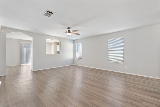 empty room featuring ceiling fan and light wood-type flooring