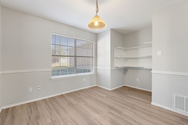 spare room featuring light wood-type flooring