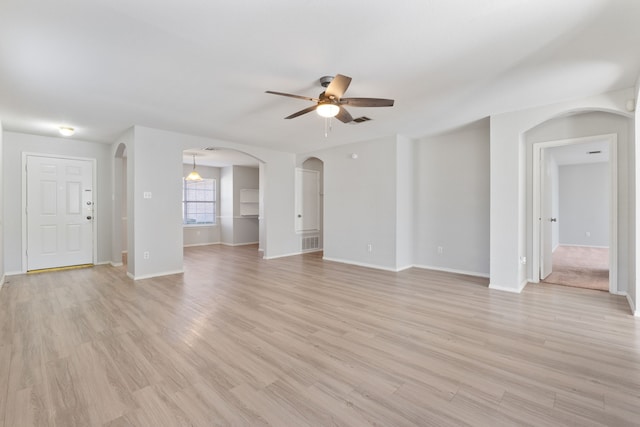 unfurnished living room featuring ceiling fan and light wood-type flooring