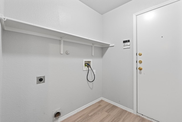 laundry room featuring gas dryer hookup, hookup for an electric dryer, hookup for a washing machine, and light wood-type flooring