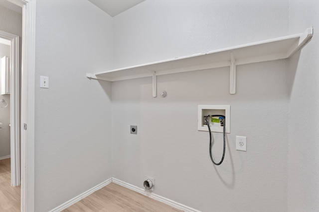 clothes washing area with washer hookup, hookup for a gas dryer, wood-type flooring, and electric dryer hookup