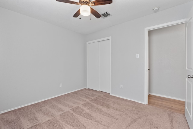 unfurnished bedroom with carpet, ceiling fan, and a closet