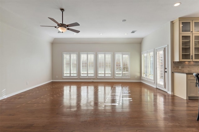 unfurnished living room with ceiling fan and dark hardwood / wood-style flooring