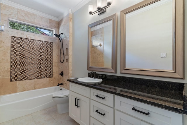 full bathroom featuring tile patterned flooring, tiled shower / bath, ornamental molding, toilet, and vanity