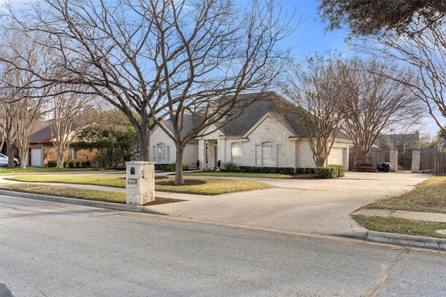 view of front of property with a garage and a front lawn