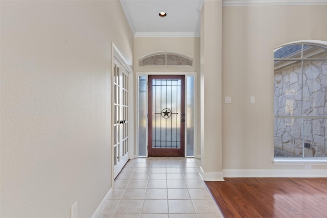 entryway featuring crown molding and light wood-type flooring