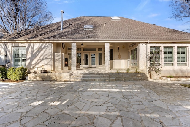 back of property with ceiling fan and a patio