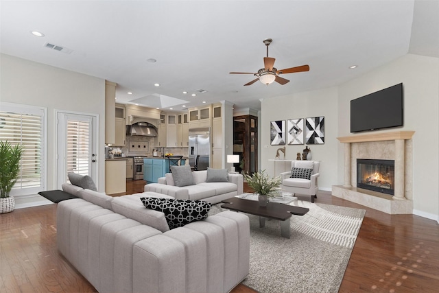 living room with a fireplace, ceiling fan, and dark hardwood / wood-style flooring