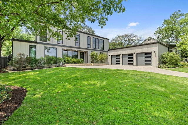 3305 Thousand Oaks Cv, Austin, TX 78746 - view of front of home with board and batten siding, a garage, and driveway