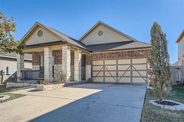 view of front of home with covered porch and a garage