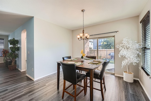 dining room featuring dark hardwood / wood-style floors and a chandelier