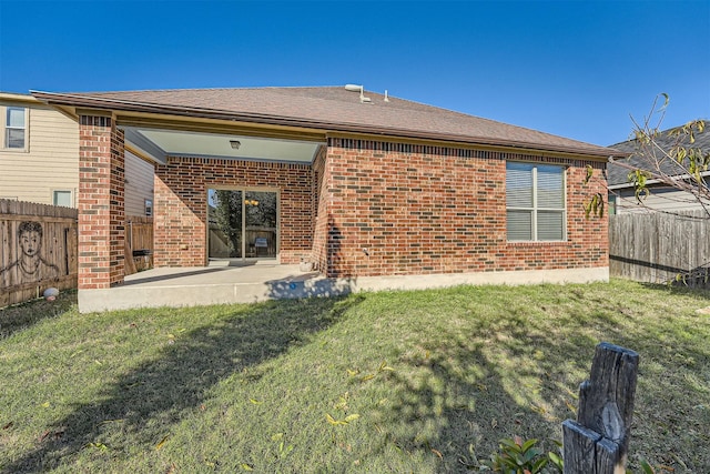 rear view of house with a patio area and a lawn