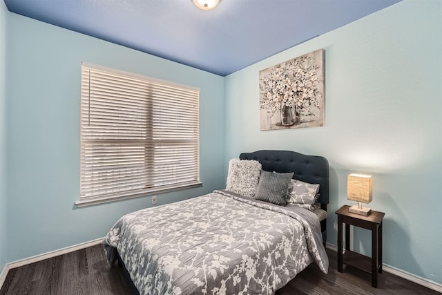 bedroom with dark hardwood / wood-style floors