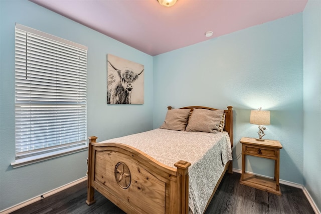 bedroom with dark hardwood / wood-style flooring