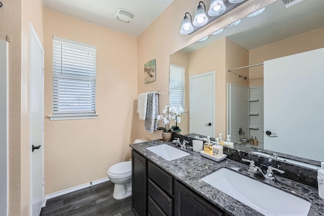 full bathroom featuring hardwood / wood-style floors, toilet, vanity, and shower / tub combination