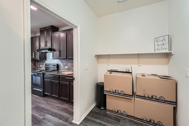 kitchen with dark brown cabinets, dark wood-type flooring, black / electric stove, and tasteful backsplash