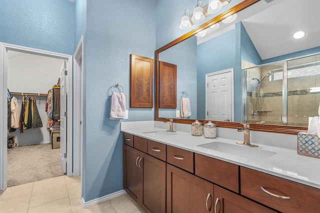 bathroom with vaulted ceiling, tile patterned flooring, an enclosed shower, and vanity