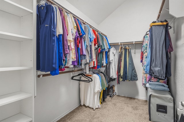 spacious closet featuring light carpet and vaulted ceiling