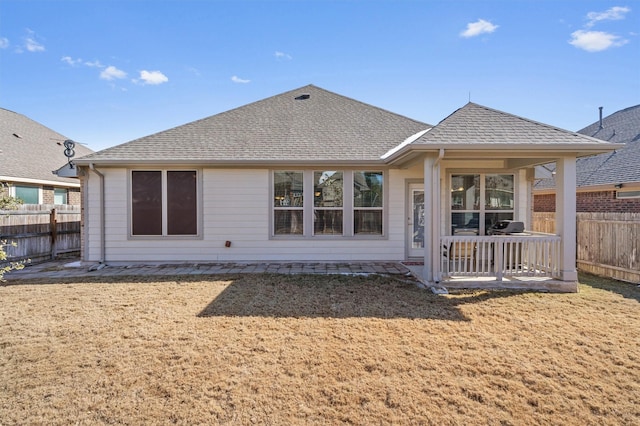 back of house featuring a lawn