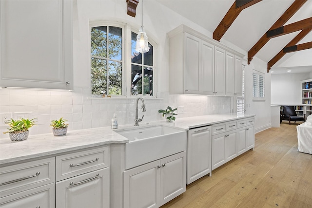 kitchen featuring white cabinets, decorative light fixtures, decorative backsplash, sink, and beam ceiling