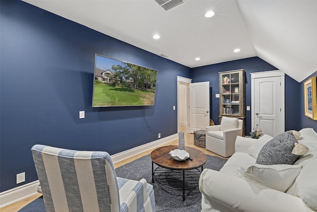 living room featuring hardwood / wood-style flooring and lofted ceiling