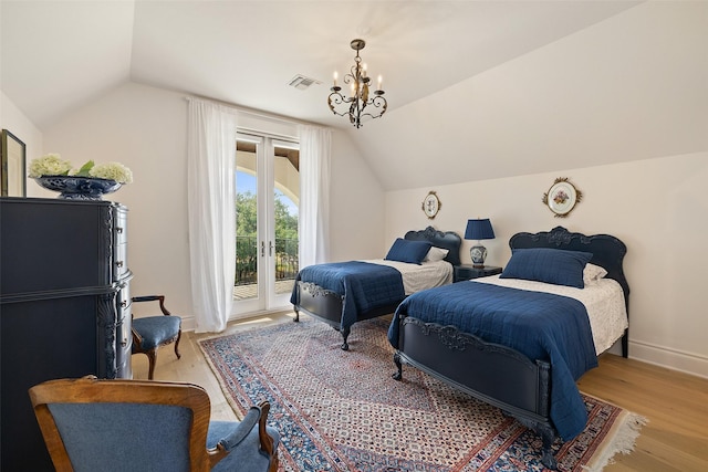 bedroom with hardwood / wood-style flooring, a chandelier, lofted ceiling, and access to outside