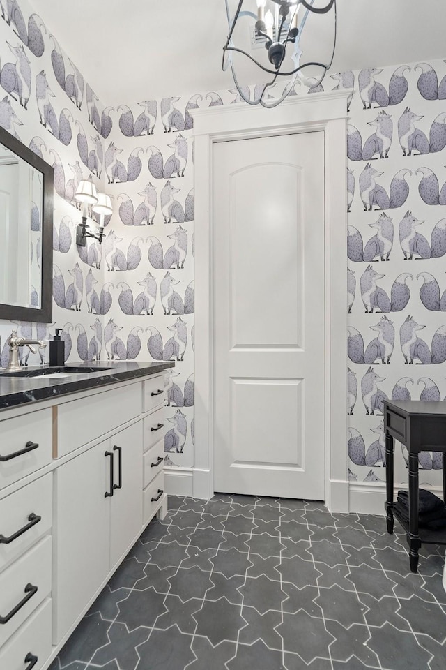 bathroom with an inviting chandelier and vanity