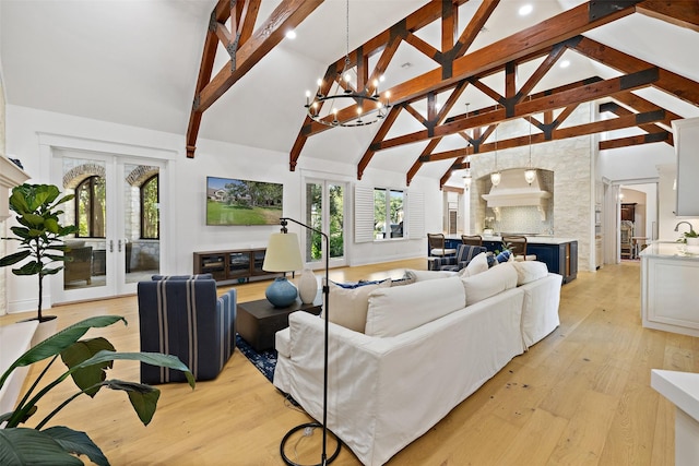 living room featuring a wealth of natural light, light wood-type flooring, french doors, high vaulted ceiling, and beam ceiling