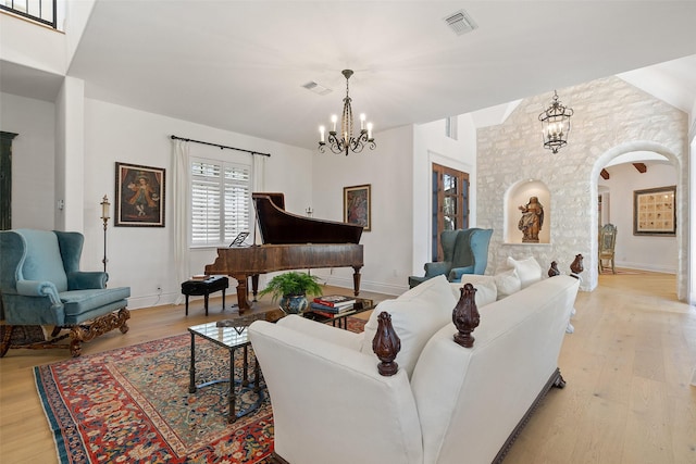 living room with light hardwood / wood-style flooring and a notable chandelier