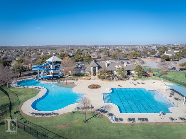 view of swimming pool featuring a patio area, a lawn, and a water slide