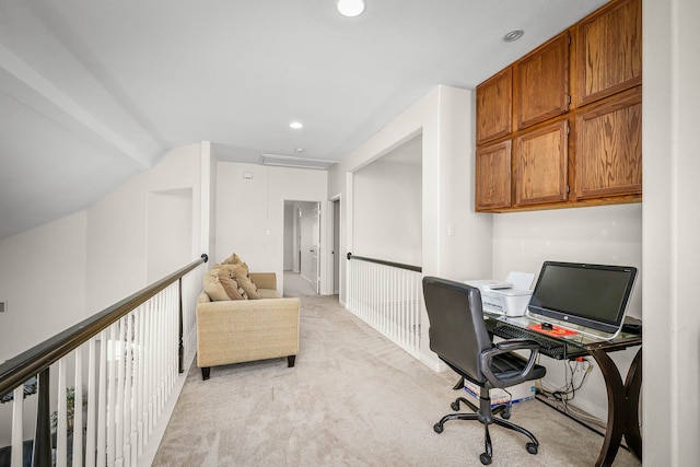 office area with vaulted ceiling and light carpet