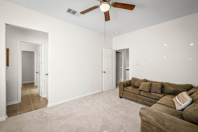 carpeted living room with ceiling fan