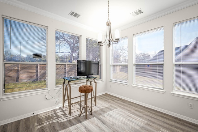 sunroom / solarium with a chandelier