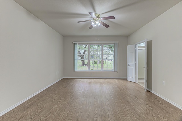 spare room with light hardwood / wood-style floors and ceiling fan