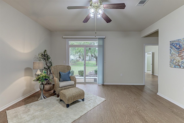 sitting room with light wood-type flooring and ceiling fan