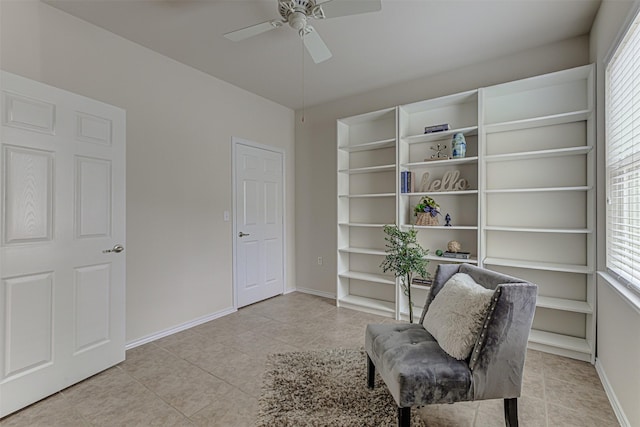 sitting room with ceiling fan and light tile patterned flooring