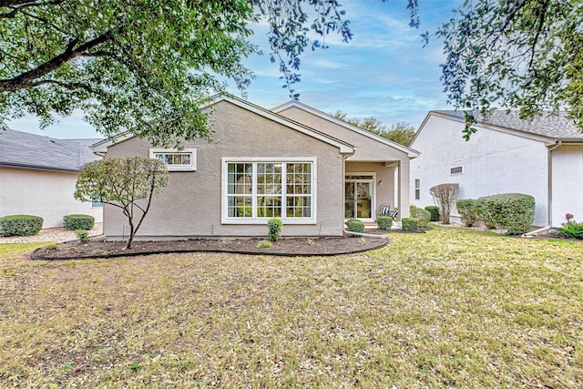 rear view of property with a yard