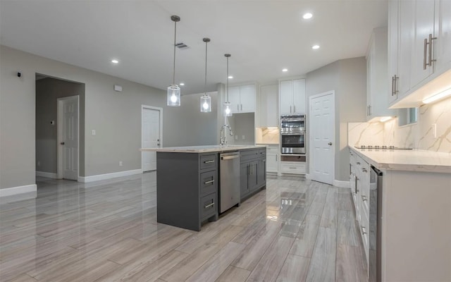 2718 Leslie Ln, San Marcos, TX 78666 - kitchen with stainless steel appliances, white cabinets, decorative backsplash, light wood-style flooring, and recessed lighting