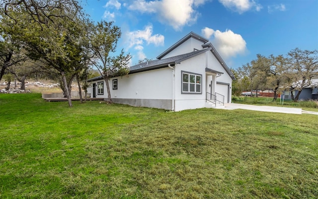 view of side of property with a garage and a yard