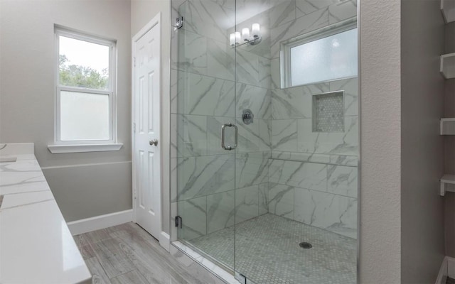 2718 Leslie Ln, San Marcos, TX 78666 - full bathroom featuring a shower stall, wood finished floors, and vanity
