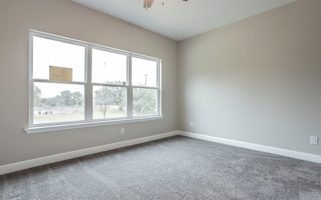 carpeted empty room with plenty of natural light and ceiling fan