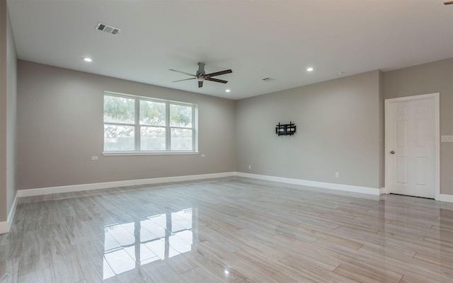 spare room featuring light hardwood / wood-style flooring and ceiling fan