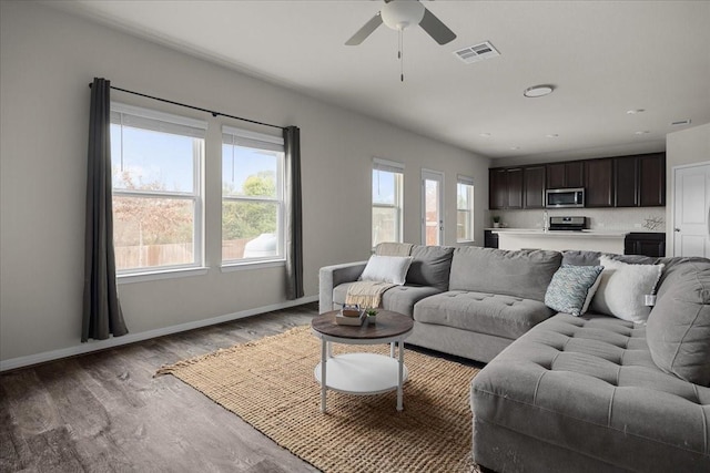 living room featuring ceiling fan and hardwood / wood-style floors