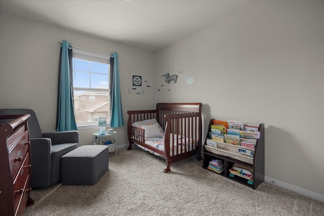 carpeted bedroom with a crib